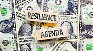 Resilience agenda symbol. Concept word Resilience agenda typed on wooden blocks. Beautiful background from dollar bills. Business