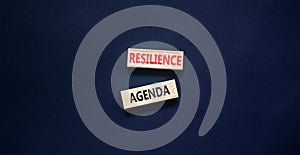 Resilience agenda symbol. Concept word Resilience agenda typed on wooden blocks. Beautiful black table black background. Business