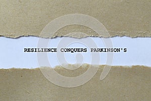 resilience conquers parkinson\'s on white paper photo