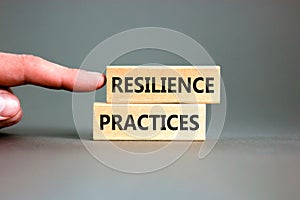 Resilience practices symbol. Concept word Resilience practices typed wooden blocks. Beautiful grey table grey background.