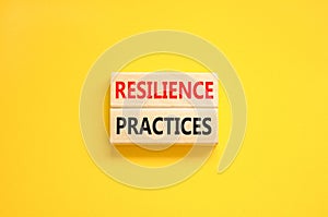 Resilience practices symbol. Concept word Resilience practices typed wooden blocks. Beautiful yellow table yellow background.