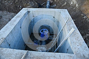 Resilient Seated Gate Valves connect pipeline of water supply in concrete bunker at constructin site. Solutions for drinking water