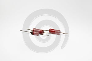 Resistor set. Three red cylindrical electronic components with leads for through-hole mounting. with clipping path for quick