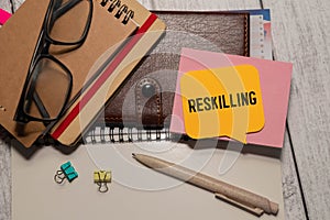 Reskilling text on sticky notes with office desk