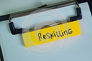 Reskilling write on sticky notes isolated on Wooden Table