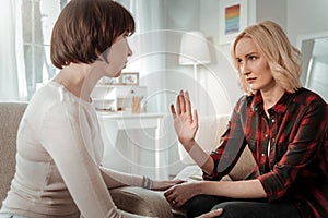 Resolute blond woman having important serious conversation