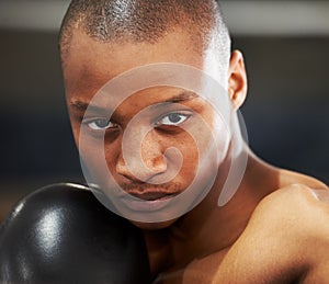 Resolved to succeed. A young boxer with determination and focus in his eyes.