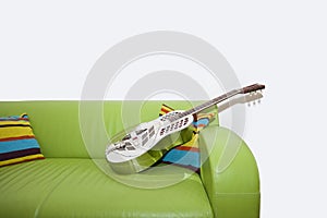 Resonator Guitar on a Green Sofa