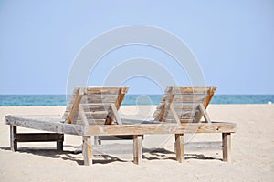 Resort beach chairs on the sand by the sea