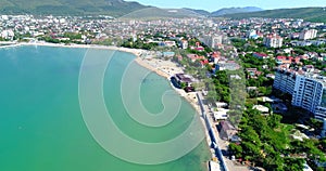 The Resort Of Gelendzhik. Flying over the beach from a bird`s eye view. A pebbly beach, rows of sun umbrellas and sun