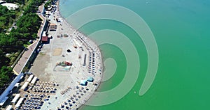 The Resort Of Gelendzhik. Flying over the beach from a bird`s eye view. A pebbly beach, rows of sun umbrellas and sun