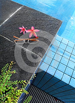 Resort hotel swimming pool, flowers and glasses