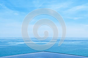 Infinity edge pool with blue sea and clear sky. Wide angle shot