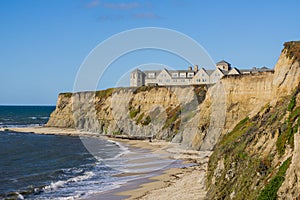 Resort on top of eroded cliffs and sandy beach, Pacific Ocean, Half Moon Bay, California