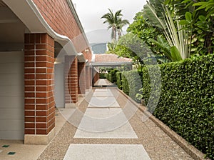 Resort way between brick wall and garden