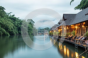 Resort wooden house floating and mountain fog on river kwai