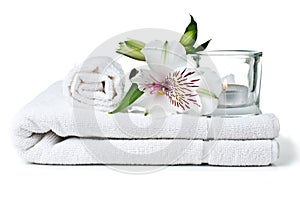 Resources for spa, white towel, candle and flower