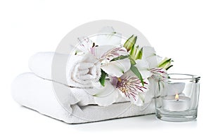 Resources for spa, white towel, candle and flower