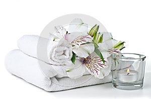 Resources for spa, white towel, candle and flower