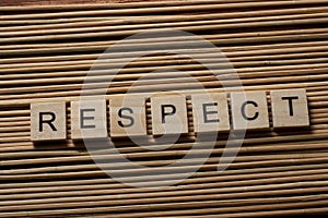 RESPECT word written on wood block ta wooden background