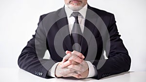 Respectable businessman sitting at office table, ready to discuss cooperation