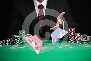 Respectable casino worker serving cards photo