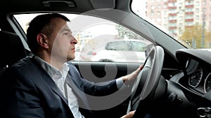 Respectable, responsible man driving car. The man holds the steering wheel. Close up