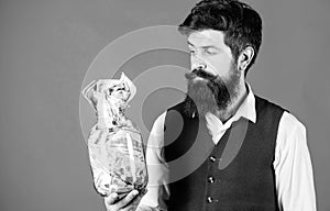 He respects money. Bearded man keeping money in glass jar. Hipster holding jar with american money. Saving money in cash