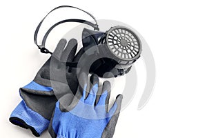 Respirator with carbon filter next to rubberized durable gloves