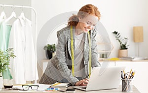 Responding on business e-mail. Dressmaker working on laptop