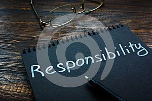 Responsibility word written on the black page.