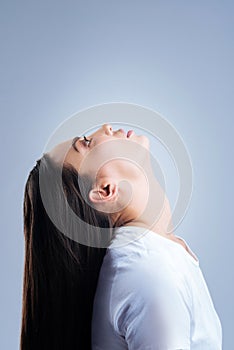 Responsible woman leaning her head back while using nasal drops