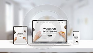 Responsive agency web page on laptop, tablet and phone display concept. Modern, flat web page design