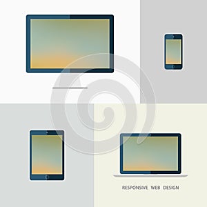 Responsive web design. Desktop monitor, laptop, tablet and smartphone. Blurred background.