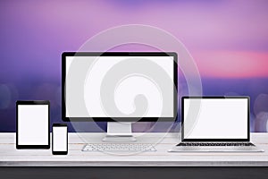 Responsive web design mockup. Devices with screen on white wooden desk