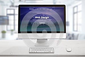 Responsive web site presentation on computer display. Office desk with keyboard and mouse