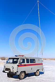 Resque car in work winter on blue sky