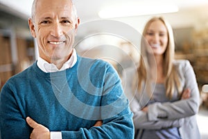 Rest assured your shipment is on its way. Portrait of a mature man standing in a warehouse with a colleague in the