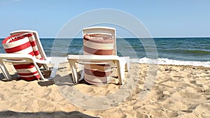 Rest on the beautiful sunny Black Sea coast. Sun loungers on the beach overlooking the beautiful sea waves. Mobile video