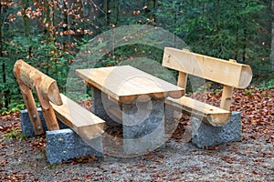 Park bench with table made of natural wood