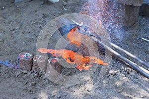 Rest of liquid metals is poured on sand.