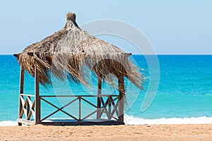 Rest shack on tropical beach on the shore of the ocean