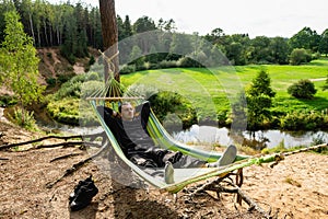 Rest in solitude in nature in a hammock stretched among the trees.