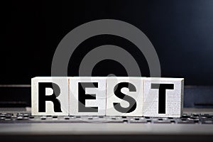 Rest word from wooden blocks on desk