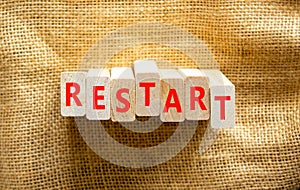 Restart and start symbol. The concept word Restart on wooden blocks. Beautiful canvas background, copy space. Business restart and