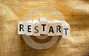 Restart and start symbol. The concept word Restart on wooden blocks. Beautiful canvas background, copy space. Business restart and