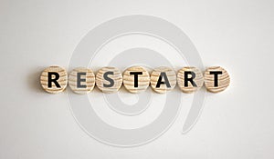 Restart and start symbol. The concept word Restart on wooden circles. Beautiful white background, copy space. Business restart and