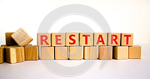 Restart and start symbol. The concept word Restart on wooden cubes. Beautiful white table, white background, copy space. Business