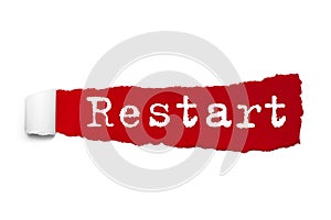 Restart word written under the curled piece of Red torn paper