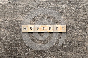 restart word written on wood block. restart text on table, concept
